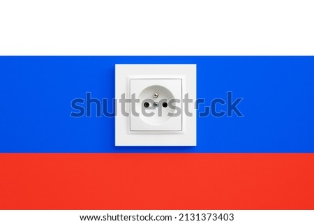 Electrical socket isolated on Russian Federation flag. Sanctions on russia background. Russian flag backdrop. Electricity price crisis.
