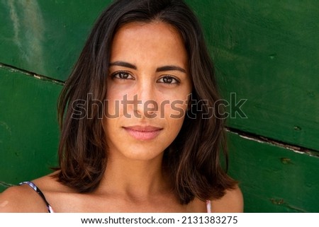 Close up front portrait young latin woman with serious face expression 