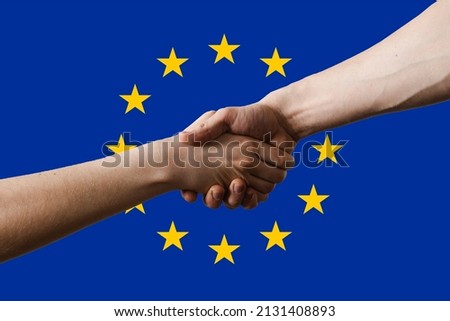 Ukraine and European union EU shaking hands each others on EU blue flag with stars background