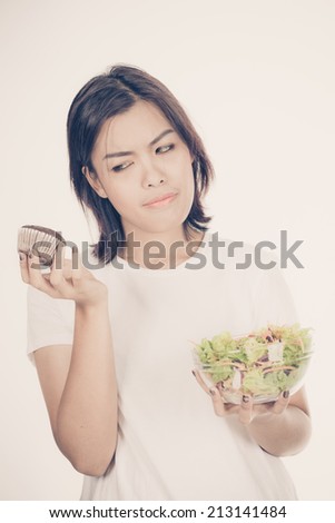 Portrait of a fit healthy hispanic woman eating a fresh salad isolated on white