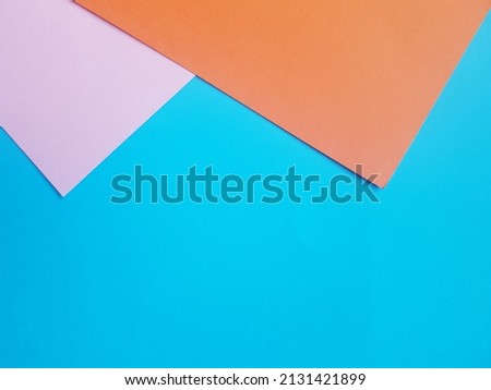 backdrop with orange, blue and pink paper.