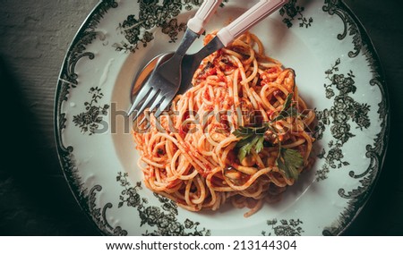 Spaghetti pasta with tomato sauce, mussels and cheese parmesan. Toned picture