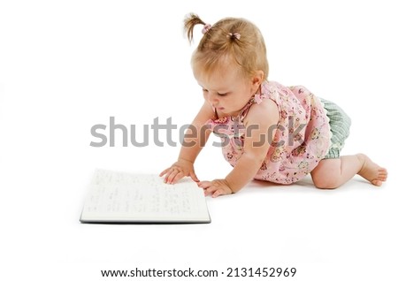 Baby girl turns the page in the notebook. Small researcher . Child concept. Isolated on white background
