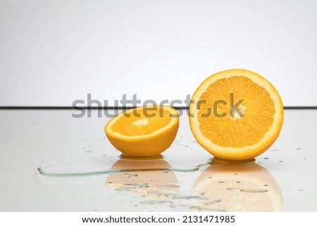 A sliced orange on a wet surface