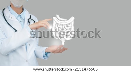 Female doctor holding virtual Intestine in hand. Handrawn human organ, copy space on right side, raw photo colors. Healthcare hospital service concept stock photo