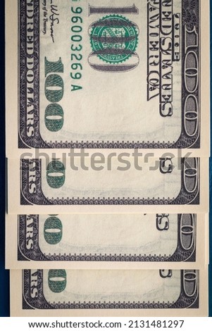 Vertical photo of several packs of hundred-dollar bills close-up of flatlay. Several hundred-dollar bills.