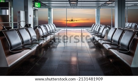 Airplane vacation concept: Empty waiting area with seats in the airport terminal.  Royalty-Free Stock Photo #2131481909
