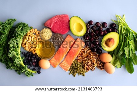 Overhead View of Fresh Omega-3 Rich Foods: A variety of healthy foods like fish, nuts, seeds, fruit, vegetables, and oil rich in omega-3 nutrients Royalty-Free Stock Photo #2131483793
