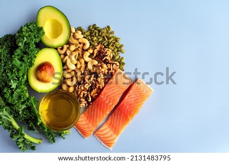 Overhead View of Fresh Omega-3 Rich Foods: A variety of healthy foods like fish, nuts, seeds, fruit, vegetables, and oil rich in omega-3 nutrients Royalty-Free Stock Photo #2131483795