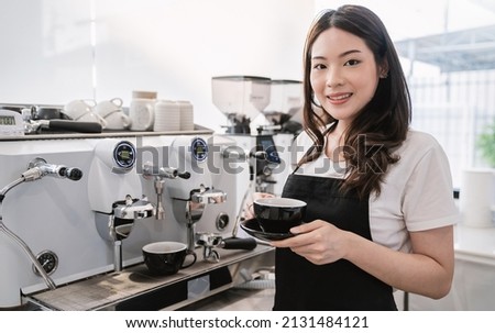 Startup successful small business owner sme woman, beauty asia girl use coffee machine in coffee shop restaurant. Portrait of asian woman barista cafe owner. SME entrepreneur business seller concept Royalty-Free Stock Photo #2131484121