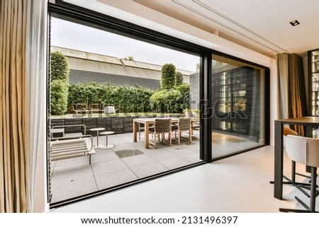 Attractive huge sliding glass door leading to the courtyard Royalty-Free Stock Photo #2131496397