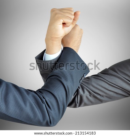 Businessman hands engage in arm wrestling