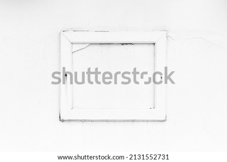 Wooden frame on cement wall with black and white tone background.