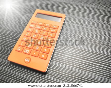 Photo of calculator with copy space and flare.
