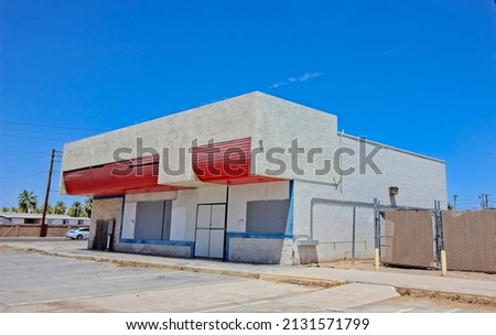 Abandoned Commercial Corner Building With Blocked Out Windows And Doors