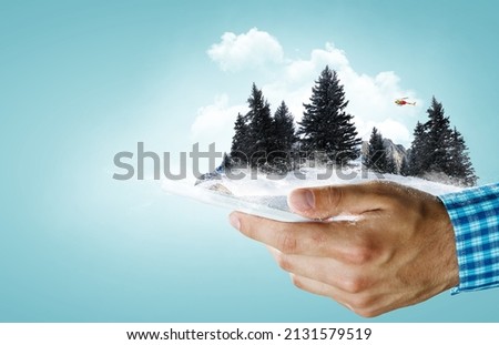 Smartphone in the hands and the mountains in winter