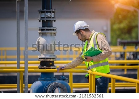Engineer take water from  wastewater treatment pond to check the quality of the water. After going through the wastewater treatment process. Royalty-Free Stock Photo #2131582561