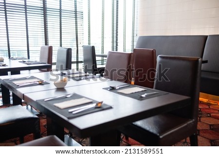 The dining table sits by the window. Blur the focus.