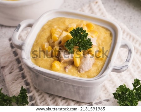 creamy corn soup or corn chowder in a white bowl, a perfect meal for cold weather , close up