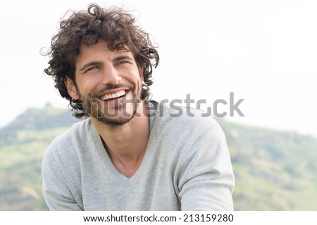 Portrait Of Young Handsome Man Smiling Outdoor Royalty-Free Stock Photo #213159280