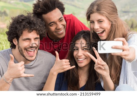 Group Of Happy Friends Taking Picture With Mobile Phone Outdoor