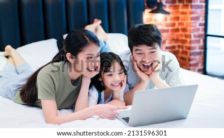 Young Asian family on the bed