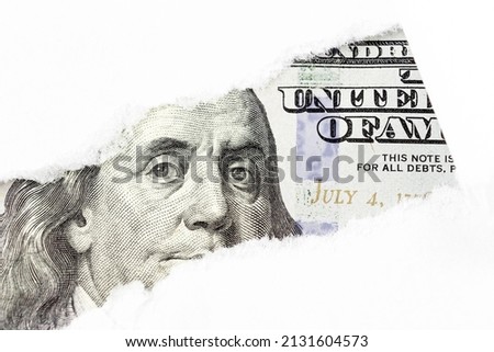 One hundred dollars bill fragment, Benjamin Franklin portrait on 100 banknote in torn paper hole. New sample money