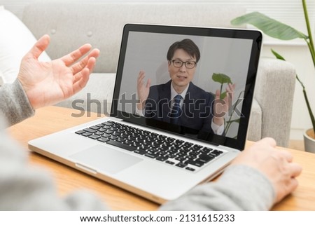 A man having a web conference on telework