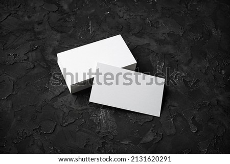 Blank business cards on black stone background. Mockup for ID. Template for graphic designers portfolios.