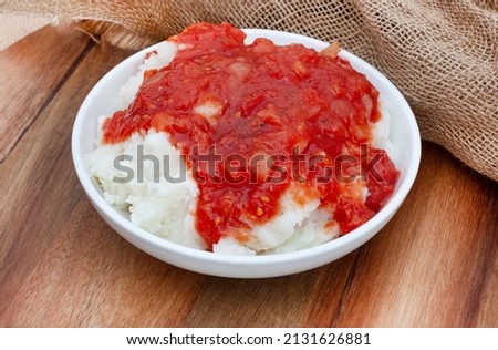 Traditional South African Pap and sous, maize meal covered in tomato and onion relish Royalty-Free Stock Photo #2131626881
