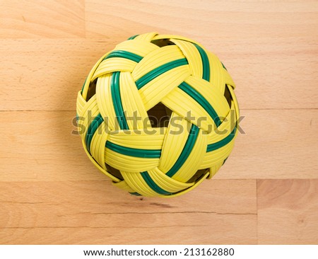 Topview of sepak ball lying on light wood floor