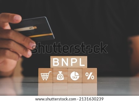 Man's hands holding credit card with BNPL icons. Buy now pay later online shopping concept. Online shopping icons. Royalty-Free Stock Photo #2131630239