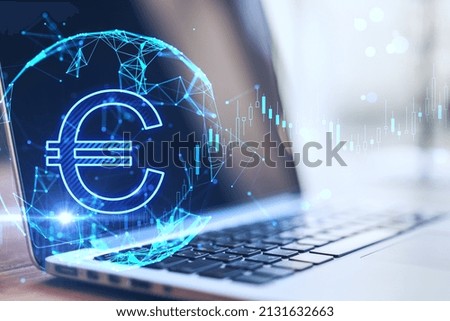 Close up of laptop with creative glowing euro and globe hologram on blurry background. Currency, online banking and market concept. Double exposure