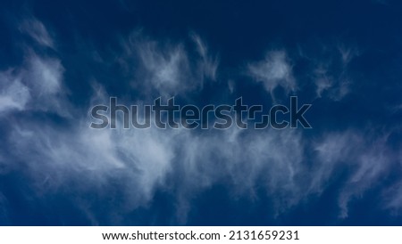 White smoky clouds in the blue sky. Spring season, May. Web banner.