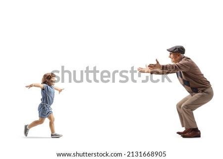 Full length profile shot of a little girl running towards an elderly man with open arms isolated on white background Royalty-Free Stock Photo #2131668905