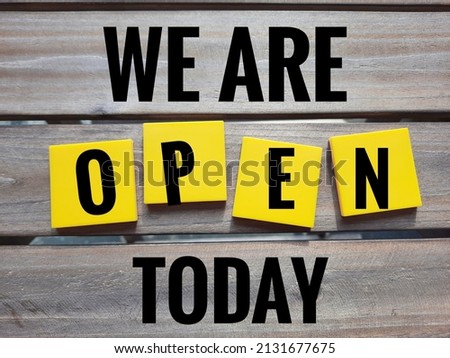 Business concept with word "We are open today" on wooden background.
