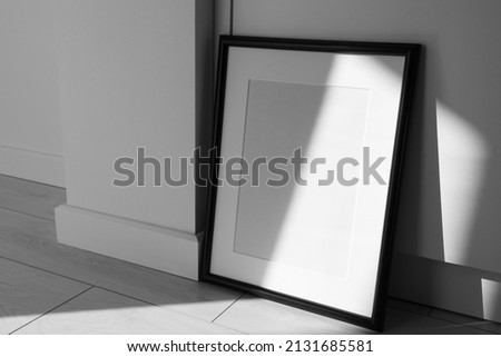 Minimalist black frame mockup on white background with shadow in interior
