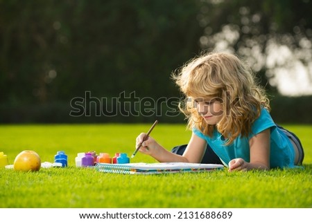 Schooler kids drawing in summer park, painting art. Little painter draw pictures outdoor. Happy child playing outside. Drawing summer theme. Imagination kids. Early childhood education. Royalty-Free Stock Photo #2131688689