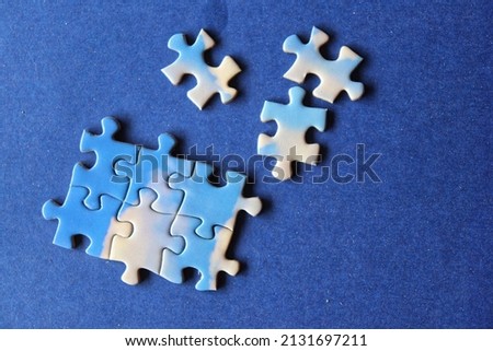 Pieces of jigsaw puzzle in blue background, photography