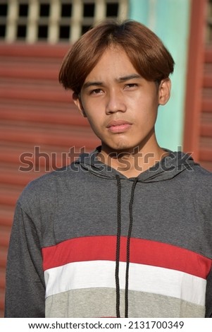 Unemotional Young Philippine Male Wearing Sweatshirt Royalty-Free Stock Photo #2131700349