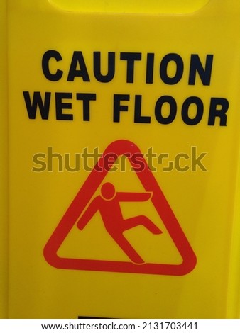 A sign with the words "Caution Wet Floor"