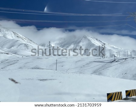 A photo of snow skating area and snow capped mountains