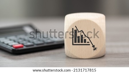 Wooden block with symbol of bankruptcy concept and calculator on background Royalty-Free Stock Photo #2131717815