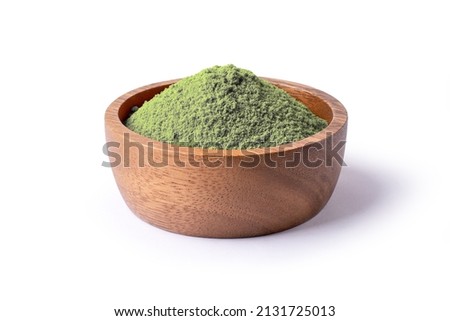 Matcha green tea powder in wooden bowl isolated on white background.