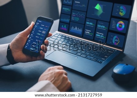 Stock market investment. Trader or broker analysing graphic
cryptocurrencies and stocks  financial data on phone.Financial Technology. Business strategy and digital marketing concept.	 Royalty-Free Stock Photo #2131727959