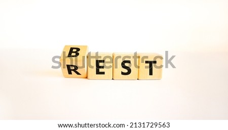 Best rest symbol. Turned wooden cubes and changed the word Rest to Best. Beautiful white table white background. Business and best rest concept. Copy space.
