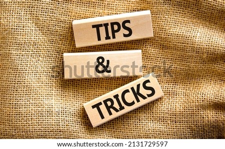 Tips and tricks symbol. Concept words Tips and tricks on wooden blocks. Beautiful canvas table, canvas background. Business, tips and tricks concept. Copy space.