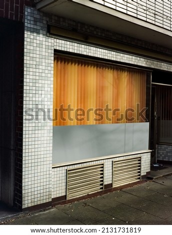 Outdoor mockup shop and storefront template, closed store window with colorful curtain.
