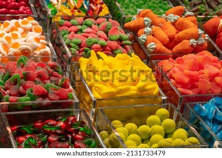 Massive amount of huge gummy candies. Colorful stall full of different gummy products. Sugar overload on one stall. Candy stall for every sweet tooth. Barcelona old food market Royalty-Free Stock Photo #2131733479