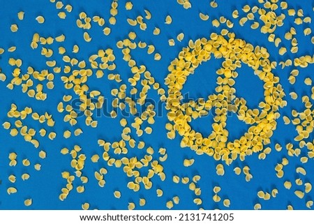 The Peace badge is made out of humanitarian aid paste on blue fabric. Colors of the flag of Ukraine. The concept of peace and cessation of war. Peace in Ukraine Royalty-Free Stock Photo #2131741205